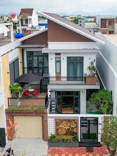 an aerial view of a two story house with balconies and plants on the balcony