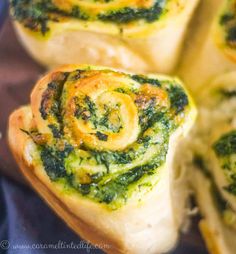 spinach rolls with cheese and sauce on them are ready to be eaten in the oven