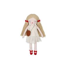 a doll with blonde hair wearing red shoes and holding a brown object in her hand