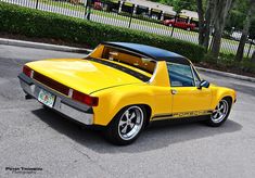 a yellow sports car parked in a parking lot