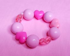 So cute and fun! Great for your Valentine's Day coords or kandi bracelet collection!💖 MATERIALS: Mint green lucite beads with pastel bow beads, on thick pink elastic cord. 💖 SIZE: Bracelet: About 7" around.💖 CARE INSTRUCTIONS: Store in cool, dry place.💖 PROCESSING TIME: 1-2 days for shipping.💖 SHIPPING: 2-5 business days within the US via USPS First Class Mail. 7-22 business days international via USPS First Class International mail. Kawaii Pink Bracelet For Party, Pink Kawaii Beaded Bracelets For Birthday, Playful Pink Heart-shaped Bracelets, Pink Heart-shaped Beaded Bracelets For Party, Cute Pink Hypoallergenic Stretch Bracelet, Kawaii Pink Beaded Bracelets, Cute Valentine's Day Stretch Bracelet With Round Beads, Cute Pink Round Beaded Bracelets, Cute Stretch Bracelet With Round Beads For Valentine's Day