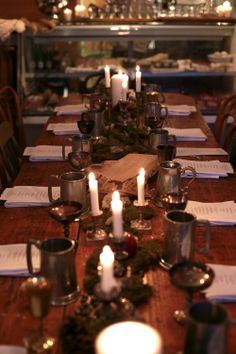 the table is set with candles and place settings