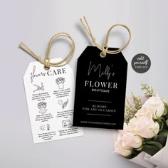 two tags with flowers on them are next to each other and tied together in twine