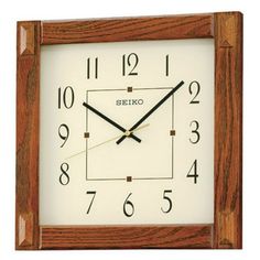 a square wooden clock with black hands and numbers