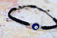 This evil eye bracelet is totally handmade in Turkey - Istanbul. Silver-plated evil eye are localized in the middle. It is black macramé which made by handmade and it is adjustable. Since it is adjustable, it is suitable for everyone. Meaning of Evil Eye : People can knowingly wish negative thoughts on you, but the power of the evil eye is that some people unknowingly and innocently cast the curse on others. That's why it's important to wear an evil eye symbol somewhere on your body or to have i Black Spiritual Friendship Bracelets With Evil Eye, Spiritual Black Friendship Bracelets With Evil Eye, Spiritual Black Evil Eye Friendship Bracelets, Spiritual Black Friendship Bracelet With Evil Eye, Adjustable Black Evil Eye Bracelet, Handmade Black Evil Eye Bracelet For Friendship, Black Evil Eye Bracelet With Sliding Knot As Gift, Handmade Round Black Friendship Bracelets, Black String Bracelet