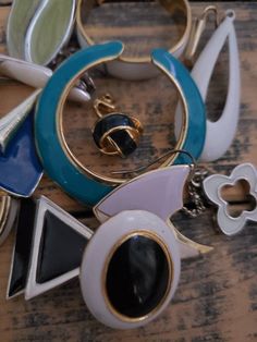 several pieces of jewelry sitting on top of a wooden table