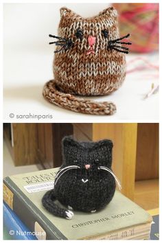 there are two knitted cats sitting on top of books, one is black and the other is brown