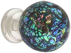 a glass door knob with blue and green designs on it