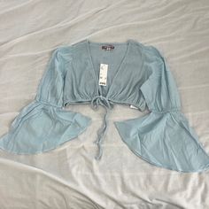 Urban Outfitters Self Tie Crop Top Size Medium Condition: Nwt Color: Light Blue Details : - Bell Sleeves - Front Tie In Front - Perfect On Your Own Or With A Tank Or Bralette Under Extras: - I Ship Between 1-2 Days Urban Outfitters V-neck Summer Blouse, Urban Outfitters Fitted Blouse For Vacation, Urban Outfitters Blouse For Spring Vacation, Fitted Blouse For Vacation By Urban Outfitters, Urban Outfitters Blouse For Vacation In Spring, Urban Outfitters Spring Vacation Blouse, Urban Outfitters V-neck Blouse For Spring, Summer V-neck Blouse By Urban Outfitters, Urban Outfitters V-neck Spring Blouse