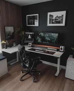 a home office with black walls and white desks, two computer monitors on each side of the desk