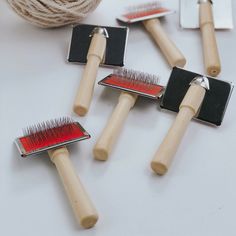 four different types of hair brushes on a table