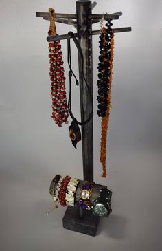 a cross with several bracelets hanging from it