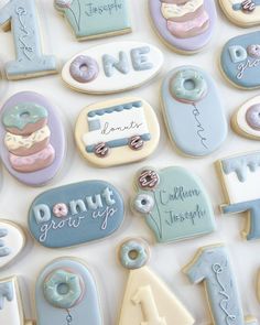 decorated cookies are arranged in the shape of numbers and donuts with frosting on them