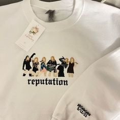 a white t - shirt with the words repuptation on it and four women in black