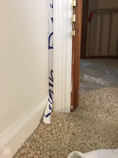 there is a white door with blue letters on it and the bottom part of the door has been stripped off