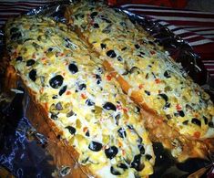 an enchilada with olives and cheese on top