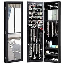 a black jewelry cabinet sitting next to a mirror