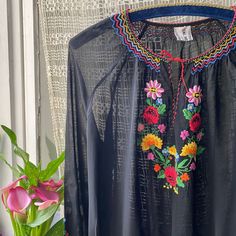 Vintage 70s black Hungarian blouse with floral embroidery, long raglan sleeve, side secret buttons fasteners, neck with ties, sheer. Label: Original Swiss Georgette, size marked 44, check the actual measurements bust 42" 107 cm bust best fit 38" 97  cm waist 28" 72 cm length 21" 54 cm sleeve 26.5" 67 cm armhole 10" 26 cm on flat Condition: great, few tiny dots and holes.  Clothing is measured on a flat surface. Please compare the actual measurements with a similar item of your clothing that fits Vintage Multicolor Embroidered Summer Blouse, Vintage Embroidered Long Sleeve Blouse, Black Embroidered Peasant Blouse, 1970s Peasant Blouse, 1970s Long Sleeve Blouse, Smocked Blouse, Body Movement, Sheer Blouse, Embroidered Blouse