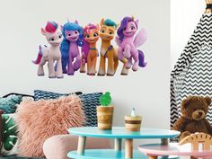 there are five little ponys on the wall in this kids's playroom