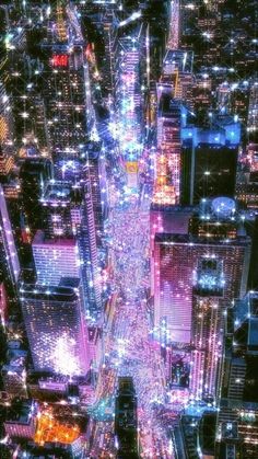 an aerial view of a city at night with skyscrapers lit up in the background