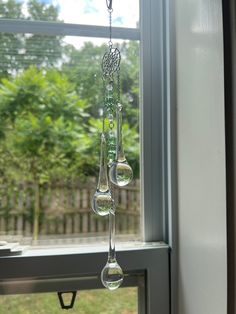 a wind chime hanging from the side of a window