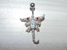 "Link to store: https://www.etsy.com/shop/VintageJewelryEden SOLD SEPARATELY New Handmade Belly button ring Shape: Moveable Scorpion / Leaping Dolphins(sold) / Iguana Lizard / Clear and Blue Spiders Barbell is standard 14 gauge, 3/8\" long made of hypoallergenic surgical stainless steel Dangle elements are sterling silver, stamped 925 All crystal cubic zirconia Colors: Various SHIPPING WORLDWIDE" Scorpion Belly Button Ring, Silver Jeweled Body Jewelry Gift, Silver Jeweled Body Jewelry For Gifts, Adjustable Silver Jeweled Body Jewelry, Snake Belly Button Piercing, Piercing Inspiration, Piercing Bar, Bellybutton Piercings, Ring Piercing