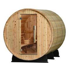 a wooden barrel sauna with the door open