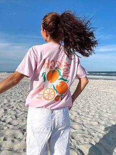 Our *EXCLUSIVE* Sunhoney Florida Orange Tshirt in Pink is your new tee to bring on your next beach vacay! Add a pop of sunshine to your wardrobe with our Sunhoney Florida Orange Tshirt in playful pink. Made with high quality fabric, printed on Comfort Colors, this shirt will not only keep you stylish but also super comfy! Product is made to order: available for pick up/ships in 2-4 business days Content: 100% Cotton Fit: TTS - size up for oversized style Model wearing size: Medium Model sizing: Cute Crew Neck T-shirt For Day Out, Relaxed Fit T-shirt With Screen Print For Day Out, Beach Season Short Sleeve T-shirt For Day Out, Pink Summer T-shirt For Day Out, Cute Graphic Print T-shirt For Day Out, Orange Relaxed Fit T-shirt For Beach, Beachy Crew Neck T-shirt With Funny Print, Pink Letter Print T-shirt For Day Out, Beachy Tops With Graphic Print For Day Out