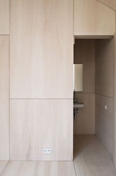 an open door leading to a bathroom with white walls