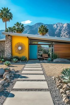 a house with yellow walls and blue doors in front of palm trees on the side