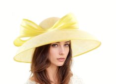 Hats By Cressida Wedding, Kentucky Derby & Ascot Hats Lemon Yellow Saskia Large Formal Ascot Hat for Kentucky Derby Church Weddings Classic Audrey Hepburn Lemon Yellow Dome Down Turned wide brimmed sinamay hat trimmed with yellow abacca silk trim The brim on the Saskia formal hat measures 41 cm side to side with a crown height of 11cm The Saskia hat has an inside circumference is 58cm.  This wide brim hat is perfect for any formal occasion such as a wedding, bridal shower, tea party or ladies luncheon.  This womans special occasion hat also is great for a day at the races like the Kentucky Derby, Ladies Day, Royal Ascot, Cheltenham, Goodwood, Dubai Cup, Breeders Bup and Spring Racing Festival.  We make each hat to order just for you, we would prefer if you did not order for choice. If colo Yellow Wedding Hat For Spring, Yellow Spring Wedding Hat, Elegant Yellow Summer Hat, Formal Yellow Hat For Spring, Elegant Yellow Hats For Garden Party, Elegant Yellow Hat For Garden Party, Elegant Fitted Yellow Hat, Elegant Yellow Wedding Hat, Tea Garden Party