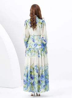 Oasis of Elegance: This stunning maxi dress is a true oasis for the eyes, flourishing with blue florals reminiscent of a serene, sunlit meadow. The lightweight fabric cascades gracefully from the demure, high-neck collar down to the soft, billowing hem, creating an impression of noble sophistication. With a tailored waist accented by a delicate belt, this dress offers a silhouette that's both flattering and enchanting. The full-length button placket adds a touch of classic charm, while the combination of sheer and opaque fabrics brings a modern twist to this timeless piece. Ideal for garden parties or elegant daytime events, this dress promises a look of refined beauty and an air of poetic poise. Fabric name: chiffonPattern: printingSkirt length: long skirtSleeve length: long sleevesColor: Blue Floor-length Midi Dress For Garden Party, Flowy Floral Print Floor-length Midi Dress, Flowy Floor-length Floral Print Midi Dress, Flowy Floral Midi Dress For Garden Party, Blue Floor-length Maxi Dress For Spring, Flowy Floor-length Floral Dress For Garden Party, Elegant Maxi Dress For Vacation Garden Party, Floor-length Flowy Floral Dress For Garden Party, Long Blue Midi Dress With Floral Print