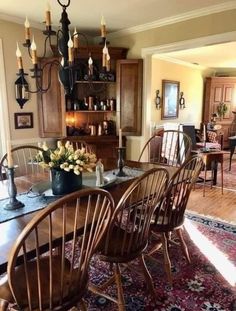 a dinning room table with chairs and a chandelier