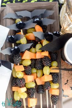 an assortment of fruits and veggies on skewers for halloween party food