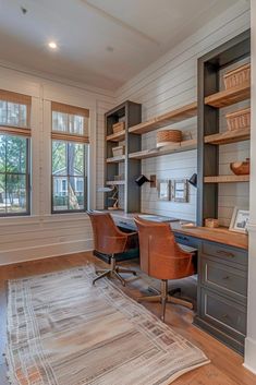 a home office with two desks and shelves