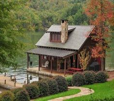 a small cabin sits on the edge of a lake