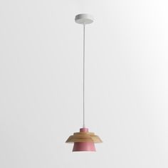 a pink and white light hanging from a ceiling