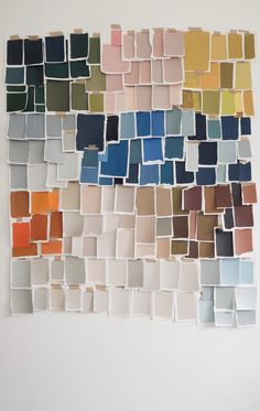 a wall with many different colors of paint swatches arranged in rows on top of each other