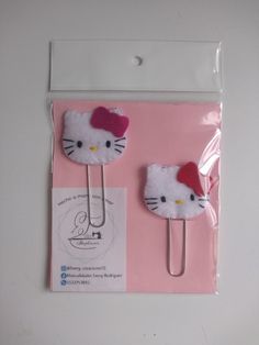 two hello kitty hair clips in pink packaging