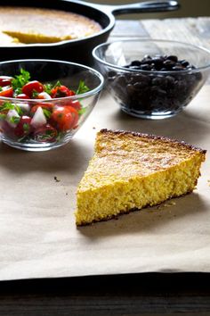 cornbread, black olives and tomatoes are on the table