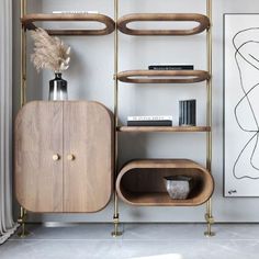 a shelf with books, vases and other items on it in a living room