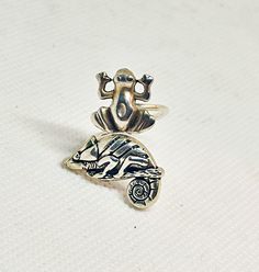 I handcrafted this ring using a beautiful silver plated over brass chameleon, a silver plated frog and a silver plated wire ring base. The ring is adjustable and fits a size 5 - 9. It comes in a gift box. Extra little GIFT included separately with the packaging! Please contact me for any questions or alterations. I will be more than happy to help you. An animal ring ideal to be given as a personalized gift to friends, family and all those you wish to pleasantly surprise! Shipping cost includes u Frog Ring, Turtle Ring, Ring Wrap, Animal Ring, Turtle Shell, Wire Ring, Shell Ring, Animal Rings, Wire Rings