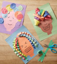 paper cut out of children's faces with scissors and crafting supplies next to them