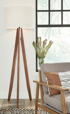 a living room with a chair, lamp and rug