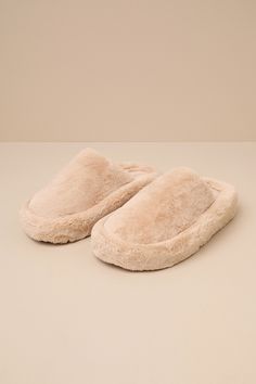 Slide through the day in maximum comfort (and style) thanks to the D'Amelio Footwear Socozee Beige Faux Fur Flatform Slippers! Super soft and fuzzy faux fur shapes the perfect slipper silhouette with a rounded toe upper and a slide-on design. Matching faux fur lines the interior for extra-cozy wear, while the chunky, flatform-inspired heel completes the look. Available in whole sizes only. 1. 75" wrapped heel. Cushioned insole. Felted rubber sole has nonskid markings. Man Made Materials. Importe Comfy Slippers With Faux Fur Lining, Winter Slippers With Faux Fur Lining For Loungewear, Winter Faux Fur Lined Slippers For Loungewear, Winter Loungewear Slippers With Faux Fur Lining, Comfortable Cozy Slippers With Faux Fur Lining, Fluffy Round Toe Slippers For Loungewear, Cozy Slippers With Faux Fur Lining, Comfy Super Soft Beige Slippers, Beige Super Soft Winter Slippers