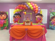 a birthday party with balloons and decorations for dora the explorer themed children's party