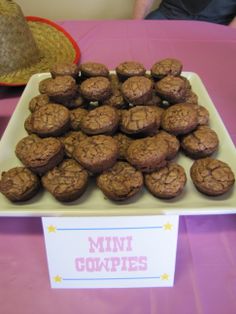 a plate full of cookies sitting on top of a pink table cloth covered tablecloth