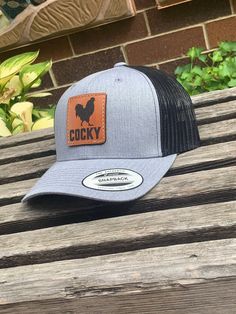 These leather patch Yupoong 6606 hats are a great way to flaunt your style and look sleek at the same time. Patches made from 100% leather and engraved with a crisp design and hand stitched on our most popular style of hat. Your friends are going to be jealous! No Set up fees, Multiple hat colors available, Bulk pricing available custom shape patches available upon request. Hat colors available -Heather Gray/Black Mesh -Charcoal Gray/White Mesh -Black/White mesh -Black/Black Mesh If a hat color Leather Patch Hat Ideas, Funny Trucker Hat, Chicken Hats, Laser Engraved Leather, Laser Engraved Ideas, Hat Patches, Leather Hats, White Mesh, Hat Ideas