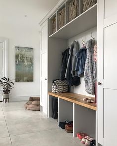 an instagram photo with clothes hanging on the wall and shoes sitting on the shelf