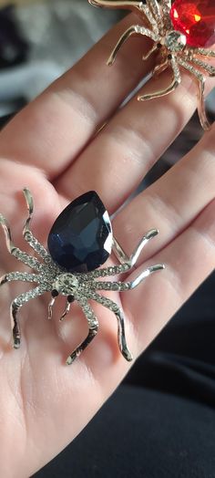 Navy blue and silver rhinestone spider brooch. Also available in silver with purple stone, silver with turqouise stone, silver with white stone, and gold with red stone. Made in a pet friendly studio. 3 to 5 days creation time. Rhinestone Spider, Spider Brooch, Halloween Pins, Purple Stones, Rhinestone Brooches, Silver Rhinestone, Red Stone, White Stone, Blue And Silver